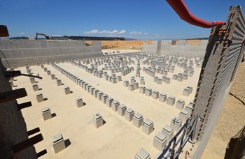 The seismic foundations of the Tokamak—reinforced basemat, retaining walls and 493 columns topped with flexible seismic pads—in March 2013. Today, they have been entirely covered over by formwork and steel reinforcement bars for the ''floor'' of the Tokamak Complex. (Click to view larger version...)